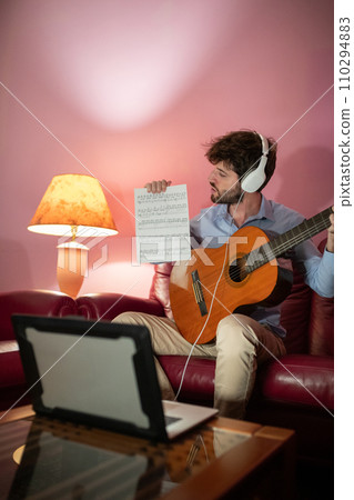 Boy Teaching Remote Music Guitar Lesson By Computer Streaming Call Boy Teaching Remote Music Guitar Lesson By Computer Streaming Call 110294883