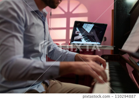 Man Teaching Piano Music Tutorial With Remote Video Streaming 110294887
