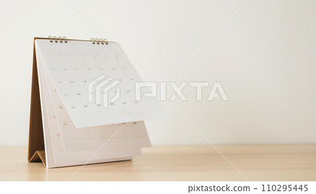 Calendar page flipping sheet on wood table background business schedule planning appointment meeting concept Calendar page flipping sheet on wood table background business schedule planning appointment meeting concept 110295445