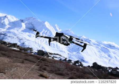 Flying drone taking picture of landscape in Tibet, China Flying drone taking picture of landscape in Tibet, China 110297820