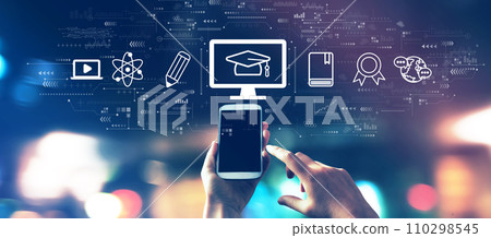 E-learning concept with a smartphone in city lights at night E-learning concept with a smartphone in city lights at night 110298545