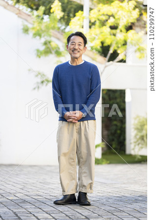 A man in his mid-50s smiling at the camera 110299747