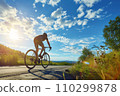 Cyclist riding bike sports outdoors on sunny day. 110299878