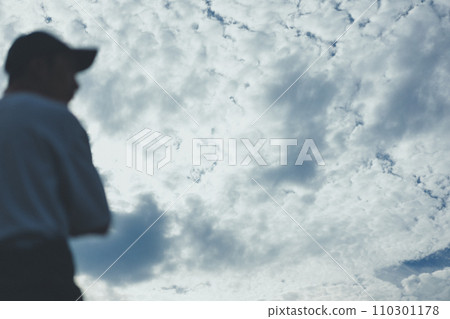 A young man with half his jumpsuit off and the blue sky A young man with half his jumpsuit off and the blue sky 110301178