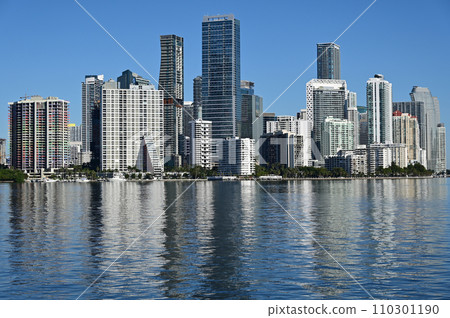 City of Miami, Florida skyline reflected in calm water of Biscayne Bay. 110301190
