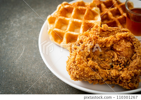 fried chicken waffle with honey or maple syrup fried chicken waffle with honey or maple syrup 110301267