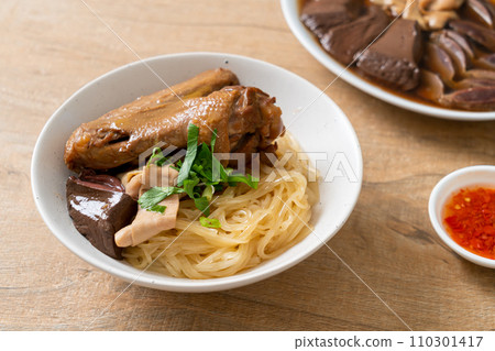 dried noodles with braised duck in white bowl 110301417
