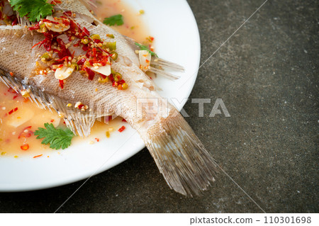 Steamed grouper fish with lime and chillies Steamed grouper fish with lime and chillies 110301698
