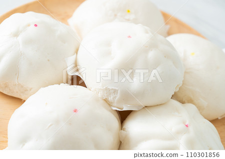 stuffed steamed bun on wood plate 110301856