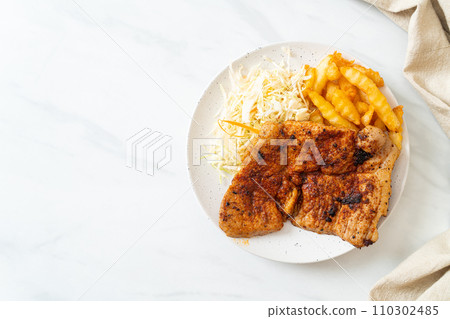 grilled spicy barbecue pork steak with french fries 110302485