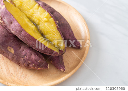 Grilled or baked Japanese sweet potatoes on wood plate Grilled or baked Japanese sweet potatoes on wood plate 110302960