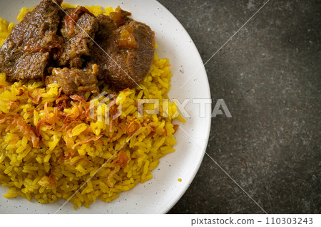 Beef Biryani or Curried rice and beef - Thai-Muslim version of Indian biryani, with fragrant yellow rice and beef Beef Biryani or Curried rice and beef - Thai-Muslim version of Indian biryani, with fragrant yellow rice and beef 110303243