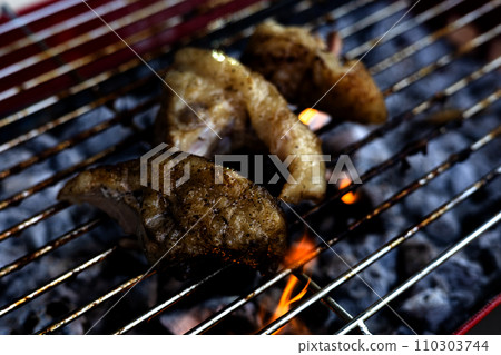 close-up of a steak on a grill. Barbecue Meat On Outdoor Grill. close-up of a steak on a grill. Barbecue Meat On Outdoor Grill. 110303744