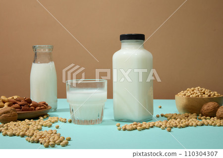 Blue surface featured a lot of soybeans and a dish containing some nuts. Soy drink is one of the easiest and most convenient choices Blue surface featured a lot of soybeans and a dish containing some nuts. Soy drink is one of the easiest and most convenient choices 110304307