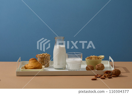Daily breakfast for healthy lifestyle with a tray featured milk, several types of nuts and a cake. Nuts have been shown to promote weight loss. Branding mockup Daily breakfast for healthy lifestyle with a tray featured milk, several types of nuts and a cake. Nuts have been shown to promote weight loss. Branding mockup 110304377