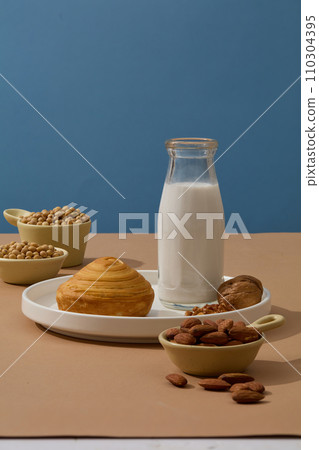 Healthy lifestyle concept with a breakfast includes soya milk, a cake and other types of nuts. Soybean (Glycine max) has a lot of advantages for both skin and health Healthy lifestyle concept with a breakfast includes soya milk, a cake and other types of nuts. Soybean (Glycine max) has a lot of advantages for both skin and health 110304395