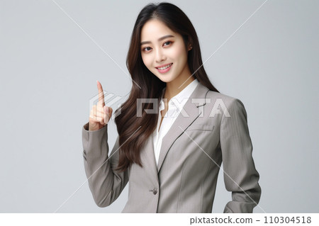 Smiling woman pointing her finger (top, NO1, suit) Smiling woman pointing her finger (top, NO1, suit) 110304518