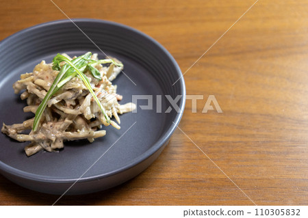 Burdock and steamed chicken salad on a plate Burdock and steamed chicken salad on a plate 110305832
