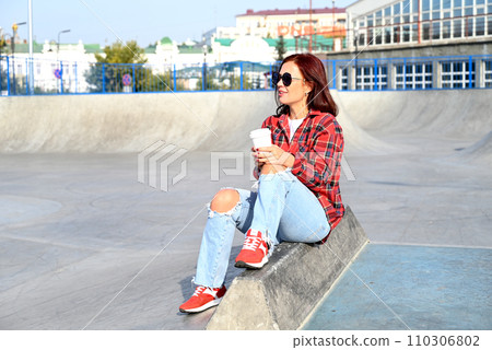 a confident young woman walks through the streets of the city, a woman smiles and enjoys life a confident young woman walks through the streets of the city, a woman smiles and enjoys life 110306802