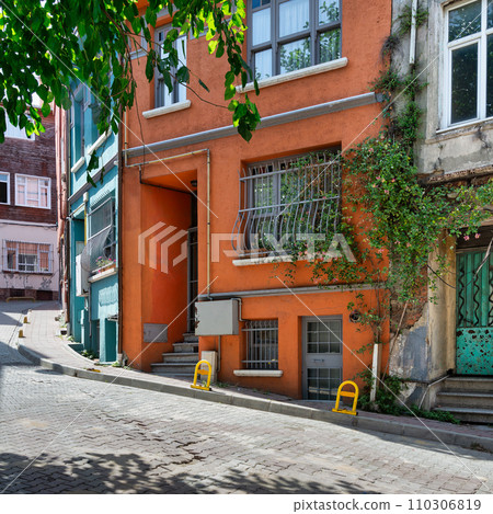 Cobblestone alley with traditional orange painted house in old Balat district, on a summer day, Istanbul, Turkey Cobblestone alley with traditional orange painted house in old Balat district, on a summer day, Istanbul, Turkey 110306819