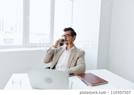 Computer man businessman smile laptop winner document office job phone glasses talk young happy 110307507