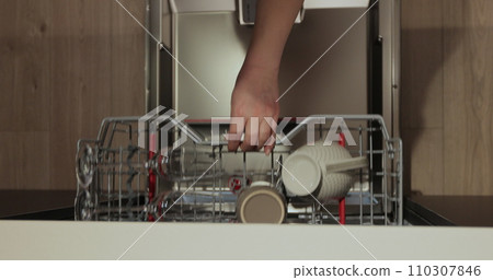 Woman open the dishwasher and takes a washed glasses from dishwasher machine. Cleaning house housewife. Close-up, top view. 110307846