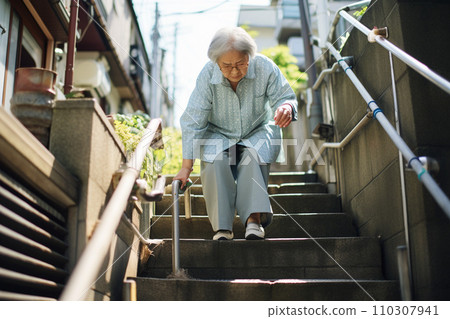 Elderly woman going up and down the stairs with difficulty: AI-generated image 110307941