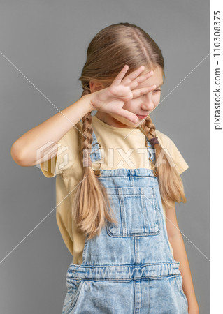 A little girl shows a sign of  protest with her hand 110308375