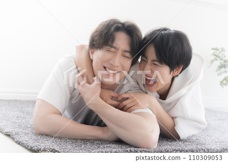 A couple having fun while lying on their stomachs 110309053