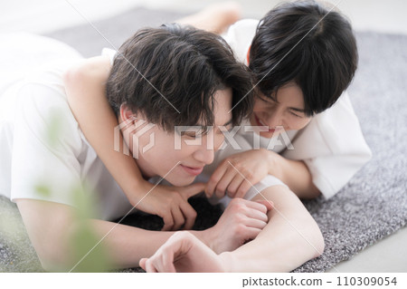 A couple having fun while lying on their stomachs A couple having fun while lying on their stomachs 110309054