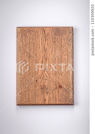 Empty wooden rectangular cutting board on a plain background, flatley with copy space Empty wooden rectangular cutting board on a plain background, flatley with copy space 110309920