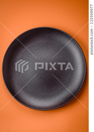 Empty round ceramic plate on a plain background, flatley with copy space Empty round ceramic plate on a plain background, flatley with copy space 110309977