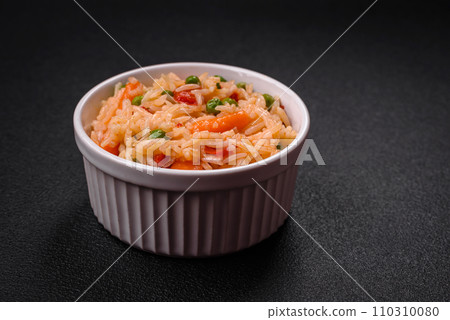Delicious boiled rice with vegetables peppers, green peas, salt, spices and herbs 110310080