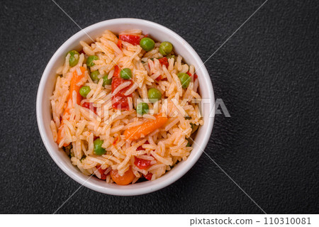 Delicious boiled rice with vegetables peppers, green peas, salt, spices and herbs 110310081
