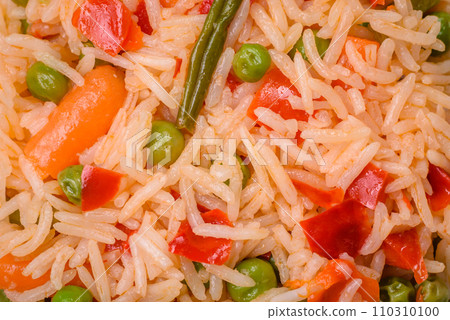 Delicious boiled rice with vegetables peppers, green peas, salt, spices and herbs Delicious boiled rice with vegetables peppers, green peas, salt, spices and herbs 110310100