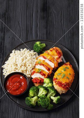baked chicken breasts with rice, broccoli on plate 110310238