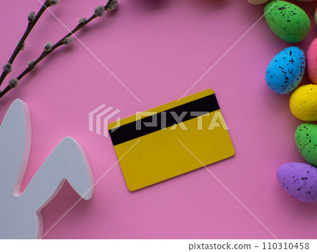 Shopping cart with colorful eggs, credit card on pink background with copy space Shopping cart with colorful eggs, credit card on pink background with copy space 110310458