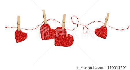 Cotton rope and four pins with hanging glitter hearts isolated on white Cotton rope and four pins with hanging glitter hearts isolated on white 110311501