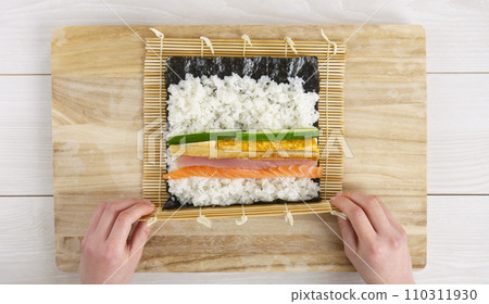 Sushi rolls. A woman making sushi rolls. Ehomaki, seafood rolls, Setsubun, etc. 110311930
