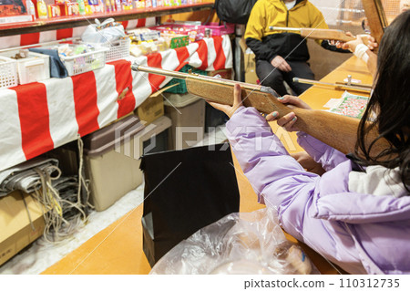 A girl shooting at a night shop 110312735