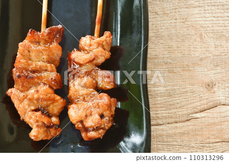 roasted slice chicken dressing Japanese teriyaki sauce stabbing wooden stick on plate 110313296