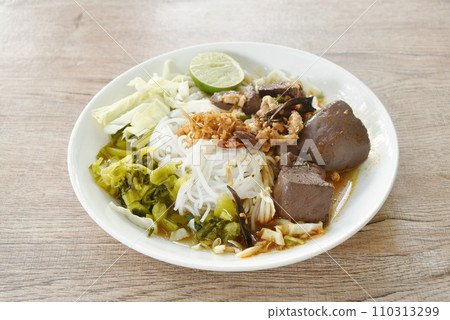 rice noodles fresh pickled and fresh cabbage eat with spicy chop pork and blood couple red cotton tree in curry sauce on plate rice noodles fresh pickled and fresh cabbage eat with spicy chop pork and blood couple red cotton tree in curry sauce on plate 110313299