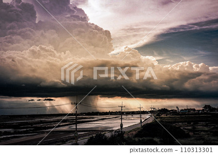 Nature Drama Unleashed Arcus Cloud Storm Over Rural Road and Salt Farm in Thailand 110313301