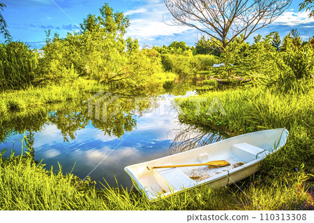 The beautiful landscape ofmall wooden rowing boat on a calm lake. The beautiful landscape ofmall wooden rowing boat on a calm lake. 110313308