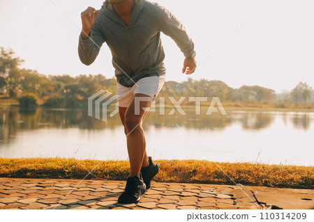 Athlete runner feet running on road, Jogging concept at outdoors. Man running for exercise..Athlete runner feet running on road, Jogging concept at outdoors. Man running for exercise. Athlete runner feet running on road, Jogging concept at outdoors. Man running for exercise..Athlete runner feet running on road, Jogging concept at outdoors. Man running for exercise. 110314209