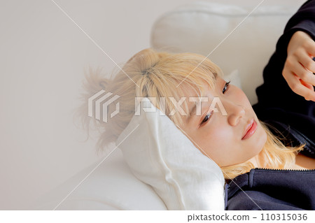 blonde woman lying on the sofa 110315036