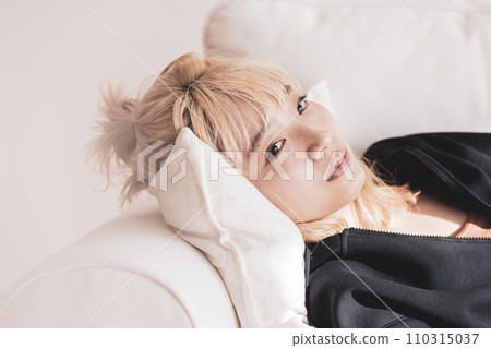 blonde woman lying on the sofa 110315037