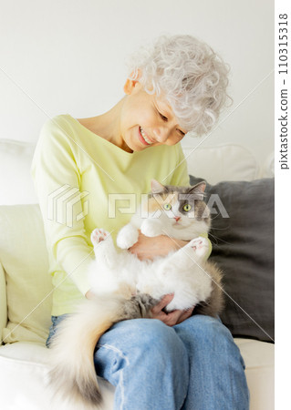 Japanese senior woman holding a cat at home (cat/owner) Japanese senior woman holding a cat at home (cat/owner) 110315318