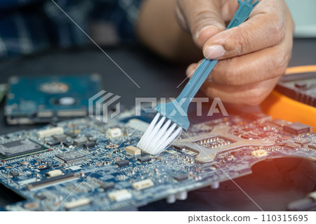 Asian technician repair and cleaning dirty micro circuit main board of smartphone electronic technology with brush, hardware, mobile phone, upgrade concept. Asian technician repair and cleaning dirty micro circuit main board of smartphone electronic technology with brush, hardware, mobile phone, upgrade concept. 110315695