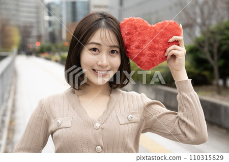 A woman with a red heart A woman with a red heart 110315829